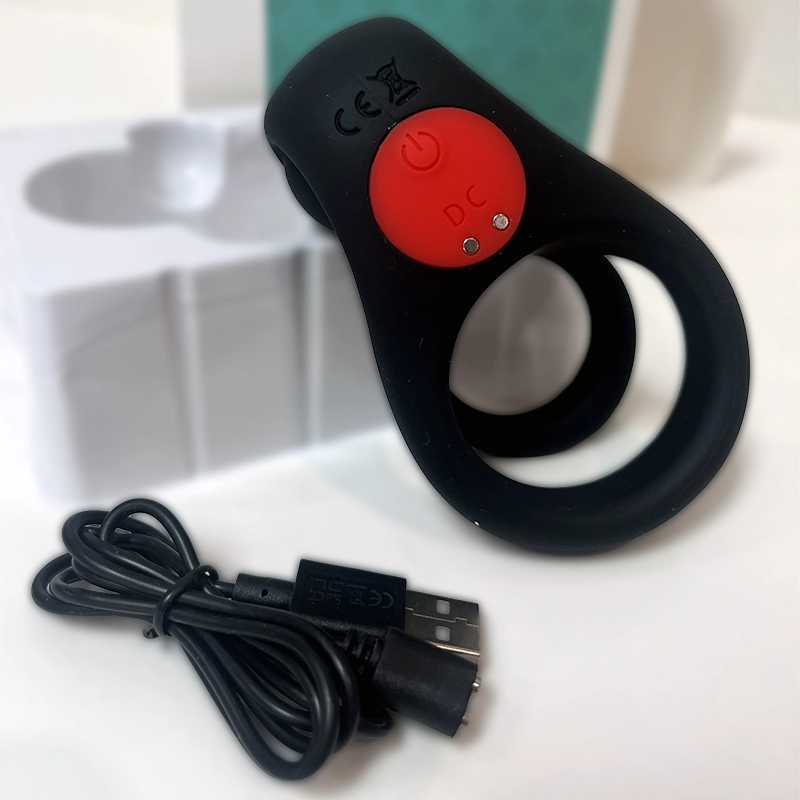The Colossus vibrating ring and USB charging cable shown with its custom packaging tray - Alpha Lover